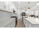 Spacious kitchen featuring white cabinets, a large island, and stainless steel appliances, perfect for culinary enthusiasts at 4345 Cadence Loop, Land O Lakes, FL 34638