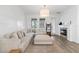 Bright living room featuring a comfortable couch, fireplace, and natural lighting at 4345 Cadence Loop, Land O Lakes, FL 34638