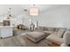 Open concept living room and kitchen with hardwood floors and ample natural light at 4345 Cadence Loop, Land O Lakes, FL 34638