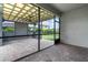 Screened patio area with brick flooring and ceiling fan perfect for outdoor dining and relaxation at 4345 Cadence Loop, Land O Lakes, FL 34638