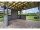 Covered outdoor patio featuring brick pavers, wood trim, and a ceiling fan, creating a relaxing space at 4345 Cadence Loop, Land O Lakes, FL 34638