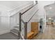 Elegant staircase with white wainscoting, gray steps, and stylish decor that enhances the home's interior at 4345 Cadence Loop, Land O Lakes, FL 34638