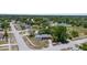 Aerial view of a residential neighborhood showcases a charming single-Gathering home nestled among mature trees at 4499 Collins Rd, Spring Hill, FL 34606