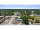 Aerial view showcases the property nestled in a lush, established neighborhood with tree-lined streets at 4499 Collins Rd, Spring Hill, FL 34606