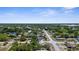 Scenic aerial view showcasing a peaceful residential area with lush greenery and clear blue skies at 4499 Collins Rd, Spring Hill, FL 34606