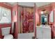 Pink bathroom featuring shower and tub combo with pink flower-themed shower curtain at 4499 Collins Rd, Spring Hill, FL 34606