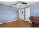 Bedroom featuring blue walls, wood flooring and multiple closets at 4499 Collins Rd, Spring Hill, FL 34606