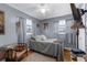 Bedroom featuring grey walls, wood flooring and multiple windows at 4499 Collins Rd, Spring Hill, FL 34606