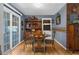 Cozy dining area features a glass-top table, classic hutch, and sliding glass doors to the exterior at 4499 Collins Rd, Spring Hill, FL 34606