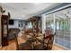 Open dining area with hardwood floors, glass-top table, and ample natural light at 4499 Collins Rd, Spring Hill, FL 34606