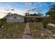 Charming single-story home with a covered front porch, well-kept lawn, and inviting curb appeal at 4499 Collins Rd, Spring Hill, FL 34606