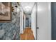 Hallway featuring decorative wallpaper, wood flooring and white doors at 4499 Collins Rd, Spring Hill, FL 34606
