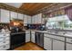 Well-lit kitchen features stainless steel appliances, ample counter space, and bright overhead lighting at 4499 Collins Rd, Spring Hill, FL 34606