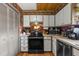 This kitchen features white cabinets, wood floors and plenty of storage space at 4499 Collins Rd, Spring Hill, FL 34606