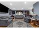 Bright living room featuring hardwood floors, neutral tones, and a decorative hutch at 4499 Collins Rd, Spring Hill, FL 34606