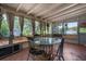 Enclosed patio with ceiling fan, views of greenery, and furniture at 4499 Collins Rd, Spring Hill, FL 34606