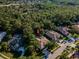 Aerial view of home surrounded by lush trees in a desirable neighborhood with golf course nearby at 4962 Turtle Creek Trl, Oldsmar, FL 34677