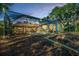 Beautiful backyard with a fire pit, covered lanai, lush landscaping, and tranquil setting at 4962 Turtle Creek Trl, Oldsmar, FL 34677