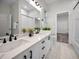 This bathroom has a double sink, large mirror, and stylish black hardware at 4962 Turtle Creek Trl, Oldsmar, FL 34677