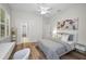 Comfortable bedroom featuring wood floors, a ceiling fan, and neutral colors at 4962 Turtle Creek Trl, Oldsmar, FL 34677