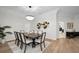 Elegant dining room with a chandelier, table with seating for eight, and stylish wall decor at 4962 Turtle Creek Trl, Oldsmar, FL 34677