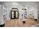 Elegant foyer boasts soaring ceilings, hardwood floors, and beautiful double doors with sidelight windows at 4962 Turtle Creek Trl, Oldsmar, FL 34677