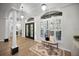 Grand foyer features elegant hardwood floors, double doors, and a sitting bench next to plantation shutters at 4962 Turtle Creek Trl, Oldsmar, FL 34677