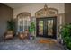 Charming front entryway features patterned glass double doors, elegant sidelights, and comfortable seating area at 4962 Turtle Creek Trl, Oldsmar, FL 34677