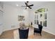 Bright home office with a glass-top desk, shuttered windows, and comfortable seating at 4962 Turtle Creek Trl, Oldsmar, FL 34677