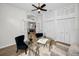Well-lit home office with glass desk, neutral rug, built-in cabinets, and an open doorway at 4962 Turtle Creek Trl, Oldsmar, FL 34677
