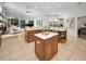 Open concept kitchen with island, custom cabinets and marble countertops, seamlessly flows to living area at 4962 Turtle Creek Trl, Oldsmar, FL 34677