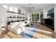 Bright living room features a cozy fireplace, large windows, and modern furnishings on hardwood floors at 4962 Turtle Creek Trl, Oldsmar, FL 34677
