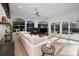 Living room featuring a fireplace, large windows, modern furnishings and sliding doors that open to a patio at 4962 Turtle Creek Trl, Oldsmar, FL 34677