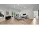 Comfortable living room with plush seating and large windows providing plenty of natural light, view to covered lanai at 4962 Turtle Creek Trl, Oldsmar, FL 34677