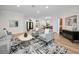 Bright living room featuring hardwood floors, neutral paint, and a view into the dining area for seamless flow at 4962 Turtle Creek Trl, Oldsmar, FL 34677