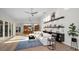 Sunlit living room boasts a fireplace, modern furnishings, and seamless connection to an open-concept kitchen at 4962 Turtle Creek Trl, Oldsmar, FL 34677