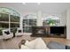 Bright living room features stained glass windows, a cozy fireplace, and seamless connection to an open-concept layout at 4962 Turtle Creek Trl, Oldsmar, FL 34677