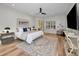 Bright and airy main bedroom with plush bed, stylish decor, and seamless access to a private outdoor space at 4962 Turtle Creek Trl, Oldsmar, FL 34677