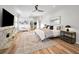 Spacious bedroom features a plush bed, ample natural light, and a seamless flow to an adjoining space at 4962 Turtle Creek Trl, Oldsmar, FL 34677