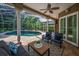 Covered patio with comfortable seating overlooking a screened pool at 4962 Turtle Creek Trl, Oldsmar, FL 34677