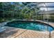Beautiful screened pool area featuring brick pavers, a luxurious spa, and ample lounging space at 4962 Turtle Creek Trl, Oldsmar, FL 34677