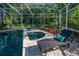 Relaxing screened pool with lush landscaping features a built-in spa for ultimate comfort and privacy at 4962 Turtle Creek Trl, Oldsmar, FL 34677