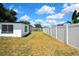 The spacious backyard features white fencing and a grass lawn at 5053 Lofton Dr, New Port Richey, FL 34652