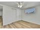 This bedroom features new floors, a ceiling fan, and a closet at 5053 Lofton Dr, New Port Richey, FL 34652