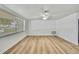 Bedroom featuring light wood flooring, a ceiling fan, and natural light from the window at 5053 Lofton Dr, New Port Richey, FL 34652