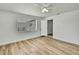Bedroom featuring light wood flooring and natural light from the window at 5053 Lofton Dr, New Port Richey, FL 34652