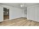 Bedroom with light wood flooring, a closet, and an exterior door at 5053 Lofton Dr, New Port Richey, FL 34652
