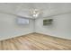 Bedroom with light wood flooring, ceiling fan, and window with natural light at 5053 Lofton Dr, New Port Richey, FL 34652