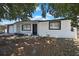 Charming single-story home featuring a white exterior, well-maintained garage, and inviting front porch at 5053 Lofton Dr, New Port Richey, FL 34652