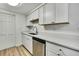 Modern kitchen featuring stainless steel appliances, light wood floors, and crisp white cabinetry at 5053 Lofton Dr, New Port Richey, FL 34652